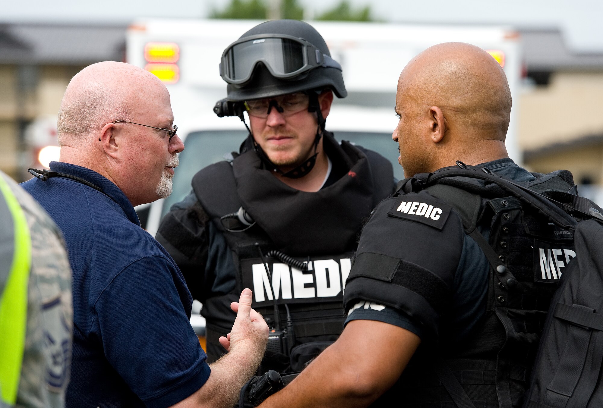 Rich Bowman, left, 436th Airlift Wing Inspector General director of inspections, discusses scenario observations with Rich Allen, center, and Scott McMillon, right, both tactical medics from the Kent County, Delaware, Department of Public Safety, Division of Emergency Medical Services, during an active shooter exercise Aug. 1, 2014, at Dover Air Force Base, Del. The active shooter exercise was confined to the Military Personnel Flight building and involved Team Dover personnel and their civilian counterparts from the Dover community. (U.S. Air Force photo/Roland Balik)