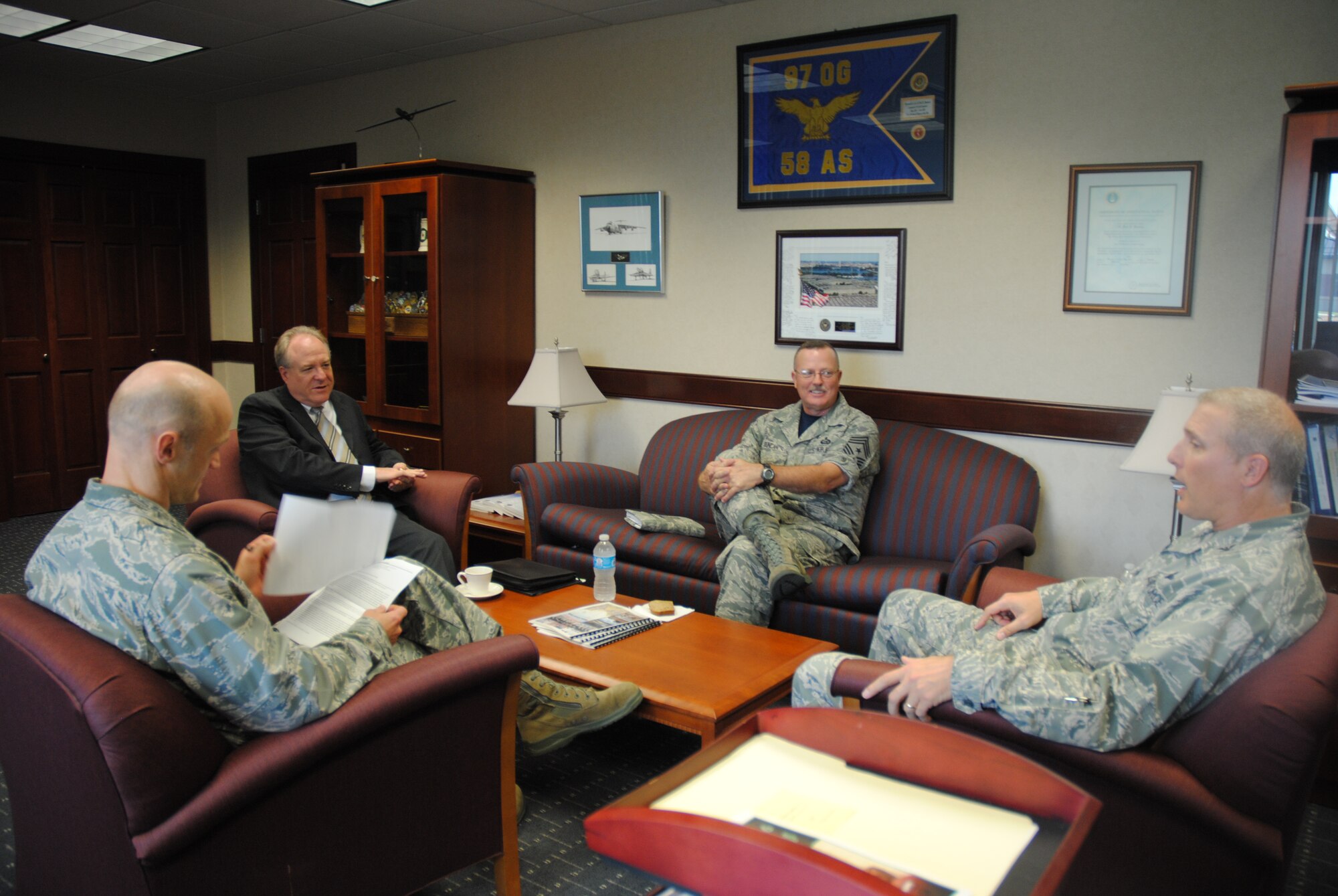 Jim Williams, Federal Aviation Administration Unmanned Aircraft Systems Integration Office manager, meets with senior leaders of the 319th Air Base Wing to discuss the status of operations for the integration of UAS in National Airspace System during an official visit to Grand Forks Air Force Base, N.D., on Aug. 15, 2014. (From left to right in uniform) Col. Robert Cook, 319th ABW vice commander; Command Chief Master Sgt. David Duncan and Col. Paul Bauman, 319th ABW commander. The 319th ABW is the host unit for tenant units such as the 69th Reconnaissance Group, which operates unmanned aircraft such as the RQ-4B Global Hawk. (U.S. Air Force photo/Staff Sgt. Luis Loza Gutierrez)