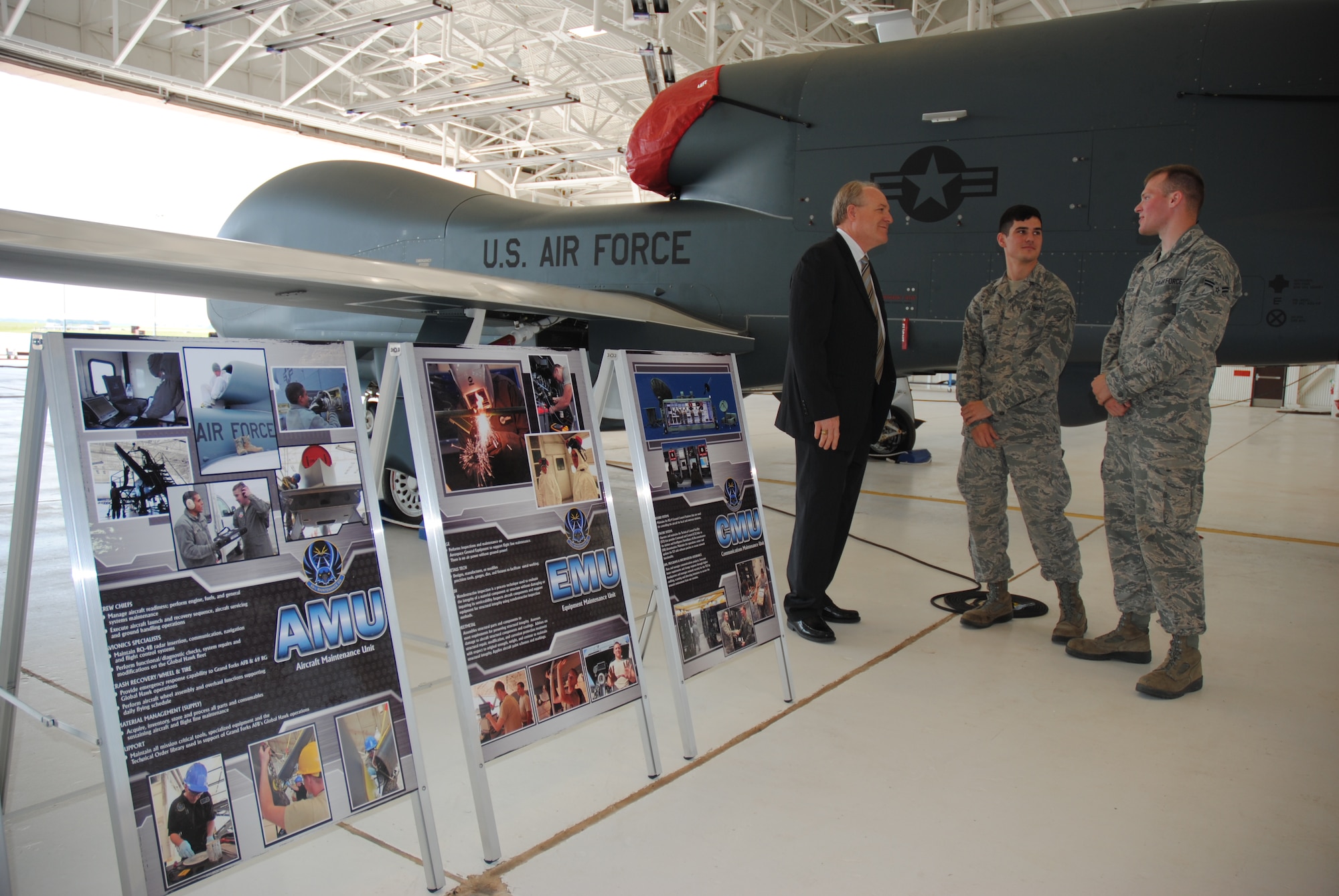 Jim Williams, Manager of the Federal Aviation Administration’s Unmanned Aircraft Systems Integration Office, speaks to two Airmen from the 69th Maintenance Squadron during an official visit to Grand Forks Air Force Base, N.D., on Aug. 15, 2014. Williams visited with the junior enlisted Airmen prior to witnessing a joint test flight of two Unmanned Aerial Vehicles, which featured one MQ-9 Reaper and one RQ-4B Global Hawk. Since being selected to be the manager of the FAA UAS Integration Office in March 2012, Williams has had the responsibility of coordinating all aspects of the FAA’s efforts to integrate UAS into the NAS. (U.S. Air Force photo/Staff Sgt. Luis Loza Gutierrez)
