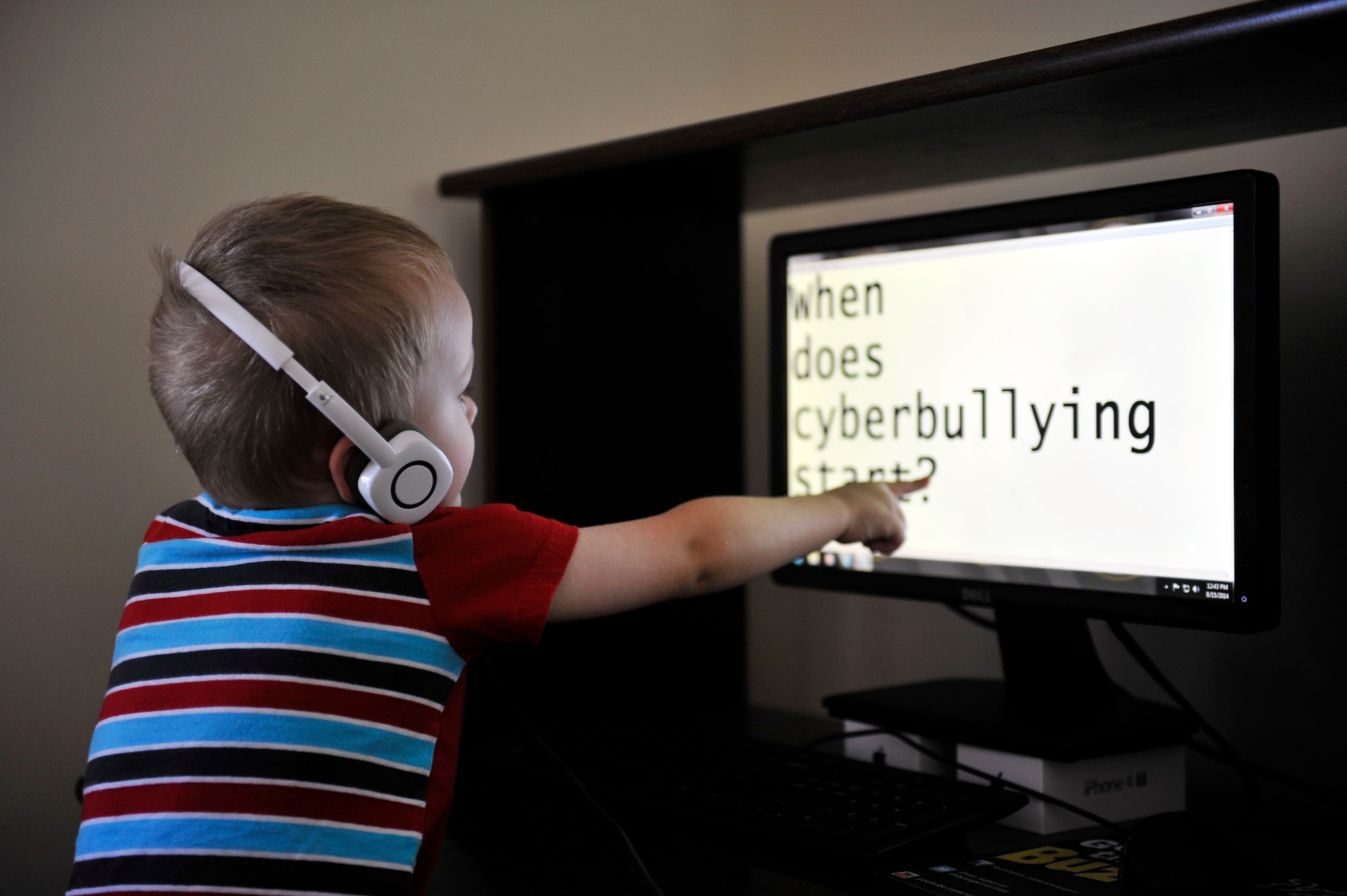 Liam Konczak, 2, uses the family computer on occasion, under the careful supervision of his dad, Mike. How early is too early for parents to consider cyberbullying and what to do if their child is in such a situation? Parents can find resources to help with this adversity their children may face, before it happens. Online bullies become more commonplace when a child has access to technology such as a computer or cell phone. Specialists suggest open communication between child and parent is paramount to identifying when their child may be the victim of cyberbullying. (U.S. Air Force photo by Airman 1st Class Erica Crossen)