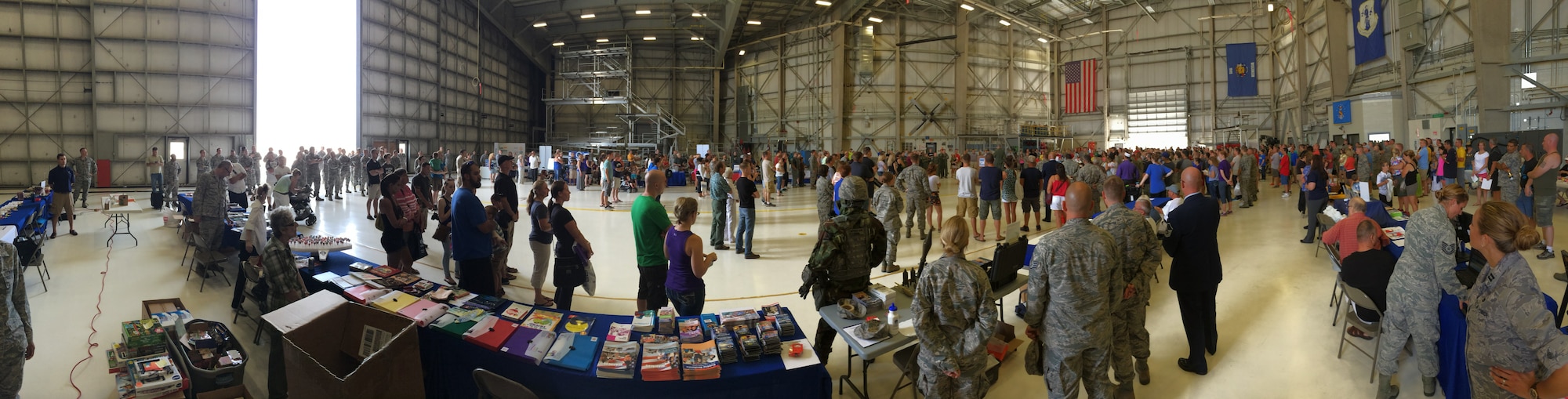 Col. James Locke, commander of the 128th Air Refueling Wing, welcomes Airmen and their families to the 128 ARW Wingman Weekend, which featured a resource information fair, games, and military displays Aug. 10, 2014 here.  More than 30 civilian and military organizations displayed booths in an aircraft hangar during the family day event to inform military members and their families of the resources and support they provide.  (U.S. Air National Guard photo by Tech. Sgt. James Michaels/Released)