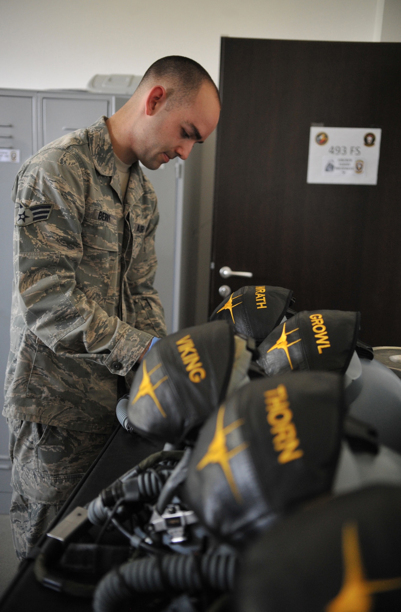 Senior Airman Jeffrey Berry, 493rd Fighter Squadron aircrew flight equipment technician, cleans and preforms post-flight checks on helmets used by pilots Aug. 15, 2014. Without the protective gear supplied to them by AFE Airmen, pilots wouldn’t be able to fly safely. (U.S. Air Force photo/Senior Airman Hailey Haux)