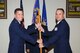 GOODFELLOW AIR FORCE BASE, Texas -- Col. Michael Grunwald Jr., 17th Training Group Commander, passes the 17th Training Support Squadron guidon to the incoming commander, Lt. Col. Steven A. Clark, during the change of command ceremony Aug. 15. The change of command ceremony is steeped in tradition and allows units to witness the formal command transfer from one officer to another. (U.S. Air Force photo/ Staff Sgt. Laura R. McFarlane)