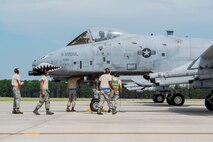 Airmen from a 23d Maintenance Group end of runway crew perform final checks to an A-10C Thunderbolt II at Moody Air Force Base, Ga., Aug. 18, 2014. End of runway crews give aircraft their last pre-flight inspections before their launch. (U.S. Air Force photo by Staff Sgt. Jamal D. Sutter/Released) 