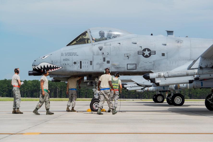 Airmen from a 23d Maintenance Group end of runway crew perform final checks to an A-10C Thunderbolt II at Moody Air Force Base, Ga., Aug. 18, 2014. End of runway crews give aircraft their last pre-flight inspections before their launch. (U.S. Air Force photo by Staff Sgt. Jamal D. Sutter/Released) 