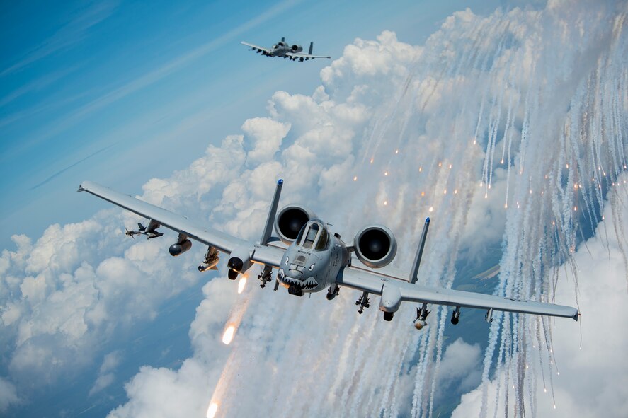 U.S. Air Force Capts. Andrew Glowa, lead, and William Piepenbring, both with the 74th Fighter Squadron out of Moody Air Force Base, Ga., launch flares from two A-10C Thunderbolt II over the skies of southern Georgia, Aug. 18, 2014. The A-10’s primary functions include close air support, forward air control and combat search and rescue. (U.S. Air Force photo by Staff Sgt. Jamal D. Sutter/Released)  
