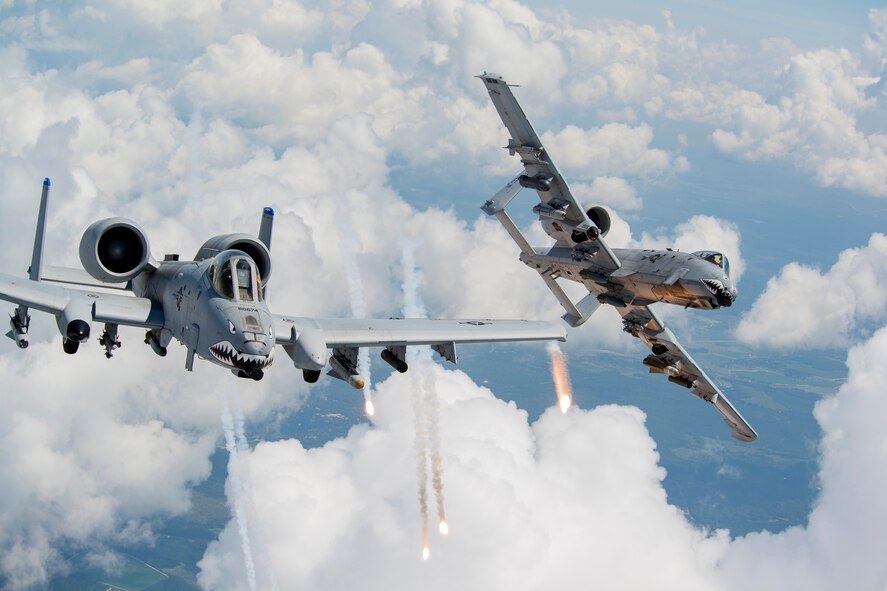 U.S. Air Force Capts. Andrew Glowa, left, and William Piepenbring, both with the 74th Fighter Squadron out of Moody Air Force Base, Ga., launch flares from two A-10C Thunderbolt II over the skies of southern Georgia, Aug. 18, 2014. Pilots, maintainers and support Airmen ensure Moody’s A-10s stay mission ready for daily training sorties and deployments downrange. (U.S. Air Force photo by Staff Sgt. Jamal D. Sutter/Released)  