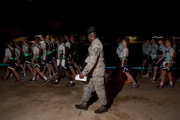 Military training instructors walk Basic Officer Training, Commissioned Officer Training and Academy of Medical Science cadets and officers back to their dorms after the Officer Training School blue line ceremony July 19, 2014, at Maxwell Air Force Base. The blue line ceremony signifies the new Airmen’s commitment to the Air Force and represents crossing from the civilian world into the military world. (U.S. Air Force photo by Staff Sgt. Natasha Stannard)