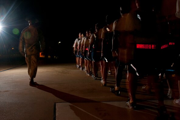The first Basic Officer Training, Commissioned Officer Training and Academy of medical science cadets and officers walk back to their dorms after the Officer Training School blue line ceremony July 19, 2014, at Maxwell Air Force Base. Approximately 346 officers and officer candidates crossed the line affirming their commitment to the U.S. Air Force. (U.S. Air Force photo by Staff Sgt. Natasha Stannard) 