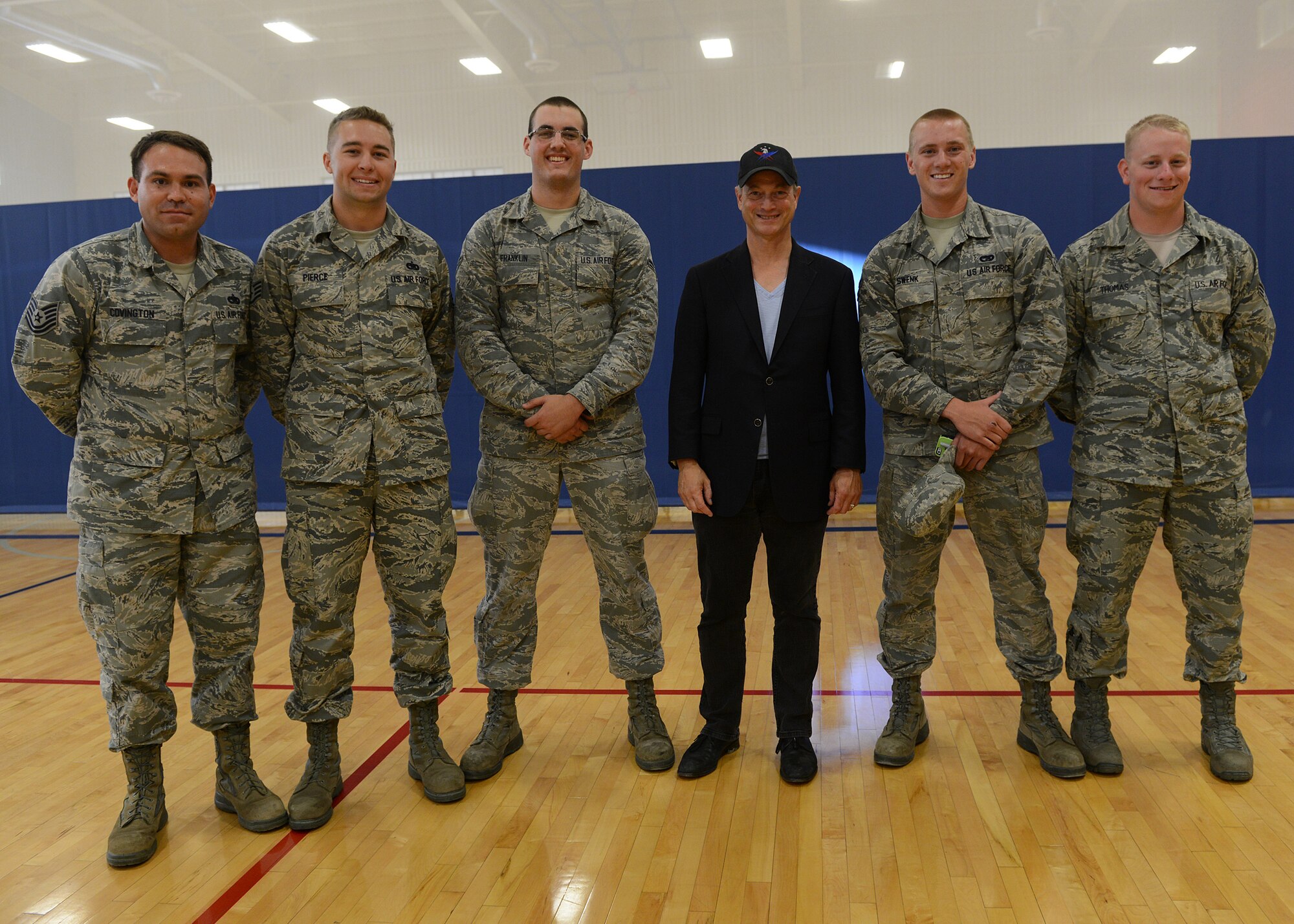 Gary Sinise, actor and member of the Lt. Dan Band (center), poses with 341st Logistics Readiness Squadron Airmen who provided transportation during his visit to Malmstrom as part of a weekend ICBM band tour Aug. 15 during a meet and greet at the base gym. From left to right are: Tech. Sgt. Mark Covington, Staff Sgt. Kyler Pierce, Airman 1st Class Evan Franklin, Airman 1st Class Joshua Swenk, and Senior Airman Justin Thomas. (U.S. Air Force photo/Senior Airman Katrina Heikkinen)