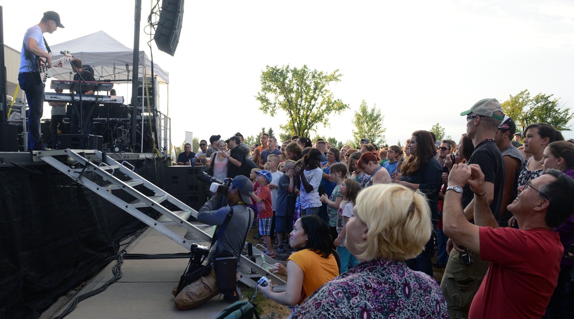 Airmen and their families listen to Gary Sinise and the Lt. Dan Band perform during a free concert Aug. 15 at Malmstrom Air Force Base, Mont. Malmstrom was his first stop as part of a weekend ICBM band tour, followed by F.E. Warren Air Force Base, Wyoming, and Minot Air Force Base, North Dakota. (U.S. Air Force photo/Senior Airman Katrina Heikkinen)