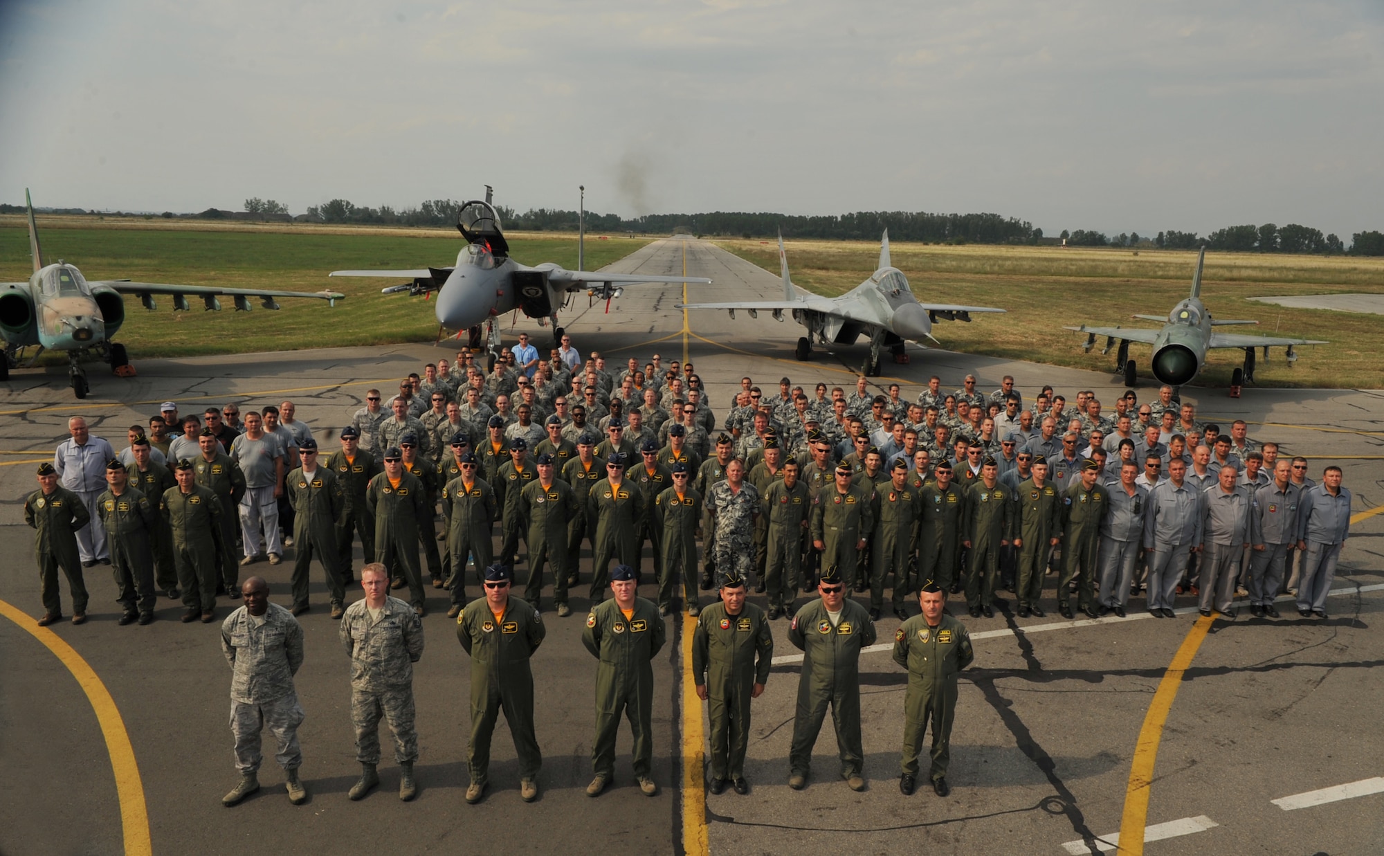 Airmen from U.S. Air Forces in Europe and Air Forces Africa pose alongside members of the Bulgarian Air Force after an opening ceremony at Graf Ignatievo Air Base, Bulgaria, August 15, 2014. Pilots, maintainers and a mixture of other professions from RAF Lakenheath, including Airmen from Ramstein Air Base, Germany will enhance interoperability with Bulgaria and maintain joint readiness. (U.S. Air Force photo/Senior Airman Hailey Haux)