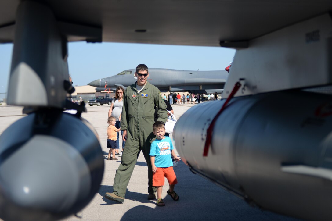 Maj. Steve Koly, 28th Bomb Wing executive officer, looks at an F-16 Fighting Falcon with his son, Jack, during Ellsworth’s Black Hills Community Appreciation Day, Aug. 16, 2014. The event featured take-offs, high-speed flybys and multiple aircraft static displays for all attendees to experience at the base. (U.S. Air Force Photo by Airman 1st Class Rebecca Imwalle/ Released)