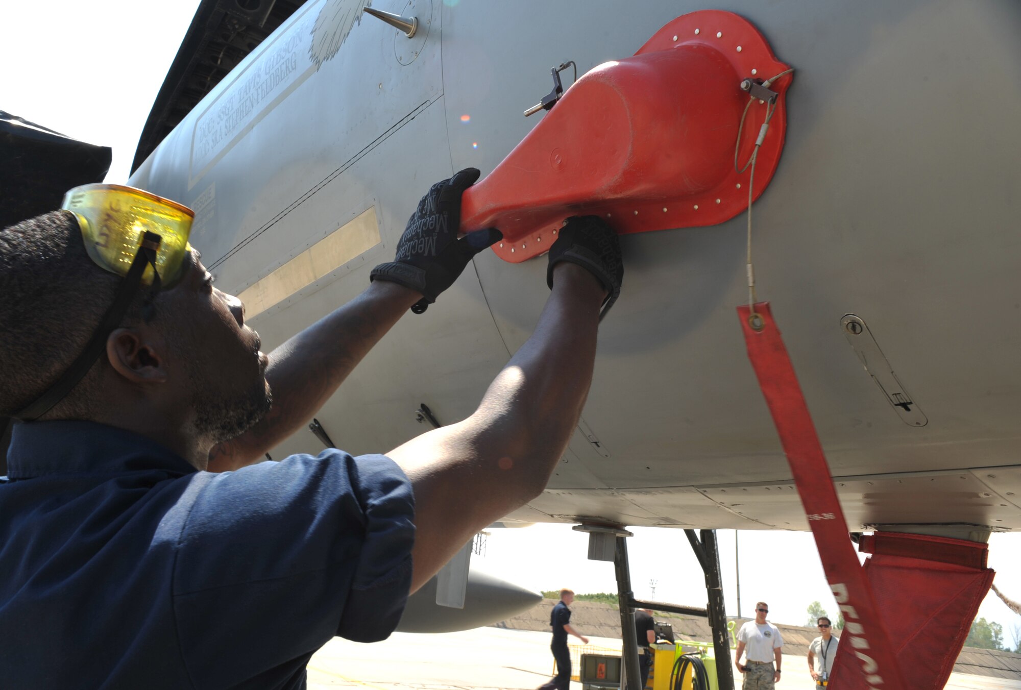 Senior Airman Najee Jarrett, 493rd Aircraft Maintenance Unit F-15 crew chief, ensures the aircraft is properly secured after flying into Graf Ignatievo Air Base near Plovdiv Bulgaria, August 15, 2014. Pilots, maintainers and a mixture of other professions from RAF Lakenheath, including Airmen from Ramstein Air Base, Germany will enhance interoperability with Bulgaria and maintain joint readiness. (U.S. Air Force photo/Senior Airman Hailey Haux)
