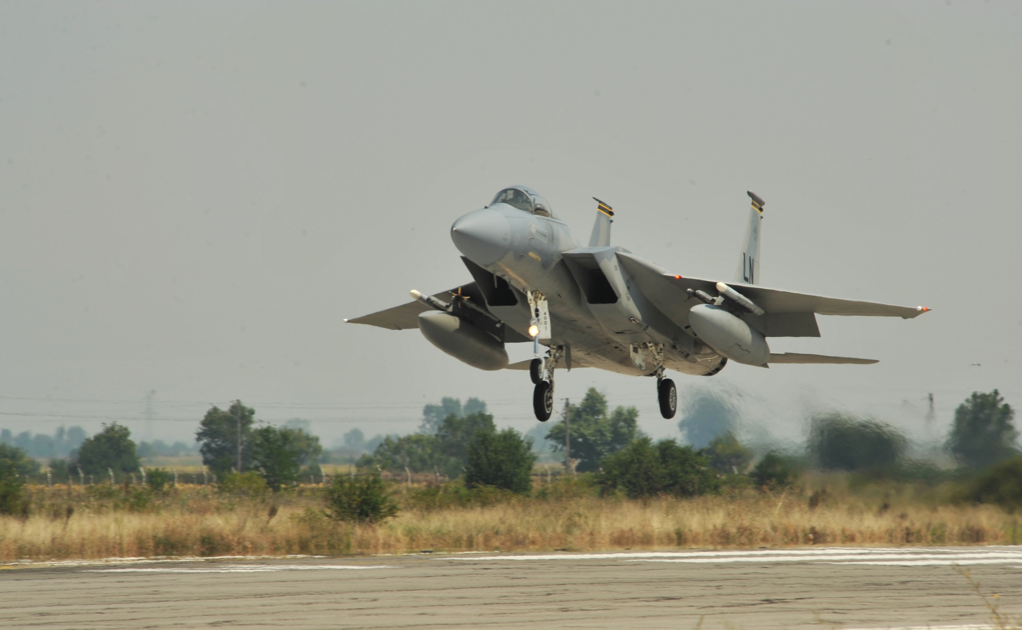 An F-15 from Royal Air Force Lakenheath, England flies into Graf Ignatievo Air Base, Bulgaria to participate in a bilateral training event, Thracian Eagle 2014, Aug. 18 through Sep. 1. Pilots, maintainers and a mixture of other professions from RAF Lakenheath, including Airmen from Ramstein Air Base, Germany will enhance interoperability with Bulgaria and maintain joint readiness. (U.S. Air Force photo/Senior Airman Hailey Haux)