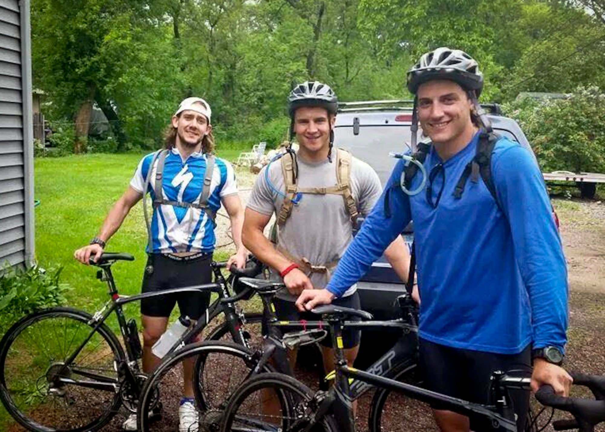 From left, Dane Bates, Senior Airman Jeffrey Isaac, and David Tilton get ready for a bike ride.  Airman Issac and his roommates have been training for the Ironman competition for the last six months.  (Courtesy Photo)