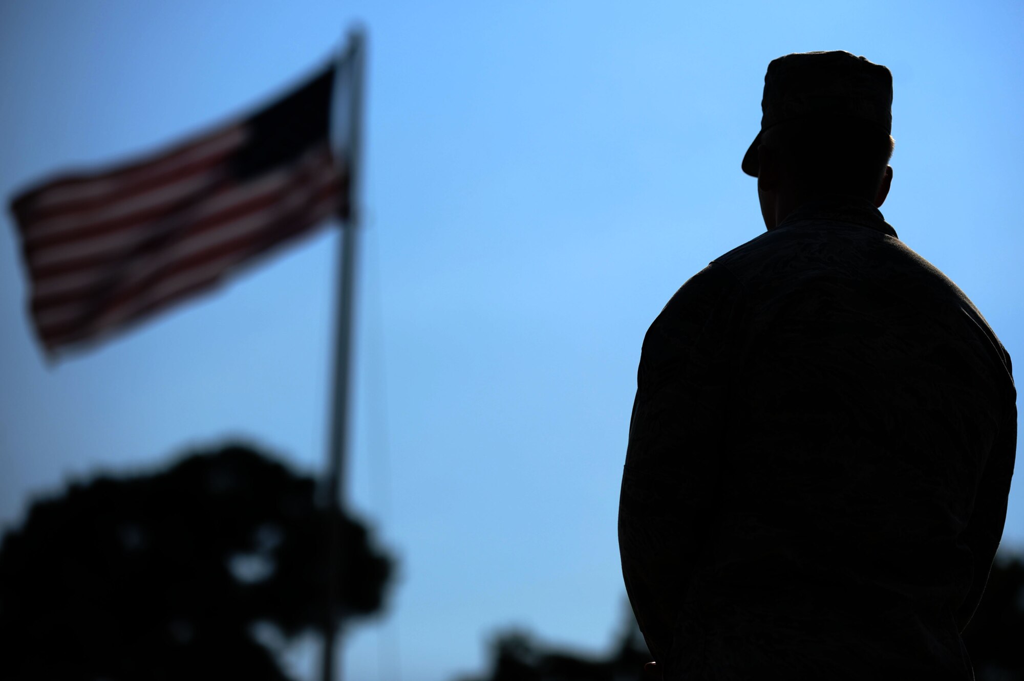 A U.S. Air Force Airman assigned to the 20th Mission Support Group gazes at the flag during a retreat ceremony at Shaw Air Force Base, S.C., Aug. 7, 2014. The 20th MSG in its entirety attends the ceremony at least once a year. "This is the second MSG Retreat ceremony we've done during my tenure as commander," said Col. Scott Arcuri, 20th MSG commander. "Retreat ceremonies have a long heritage and I felt it was important to reinforce the importance of properly honoring our flag and all that it represents."(U.S. Air Force photo by Airman 1st Class Michael Cossaboom/Released)