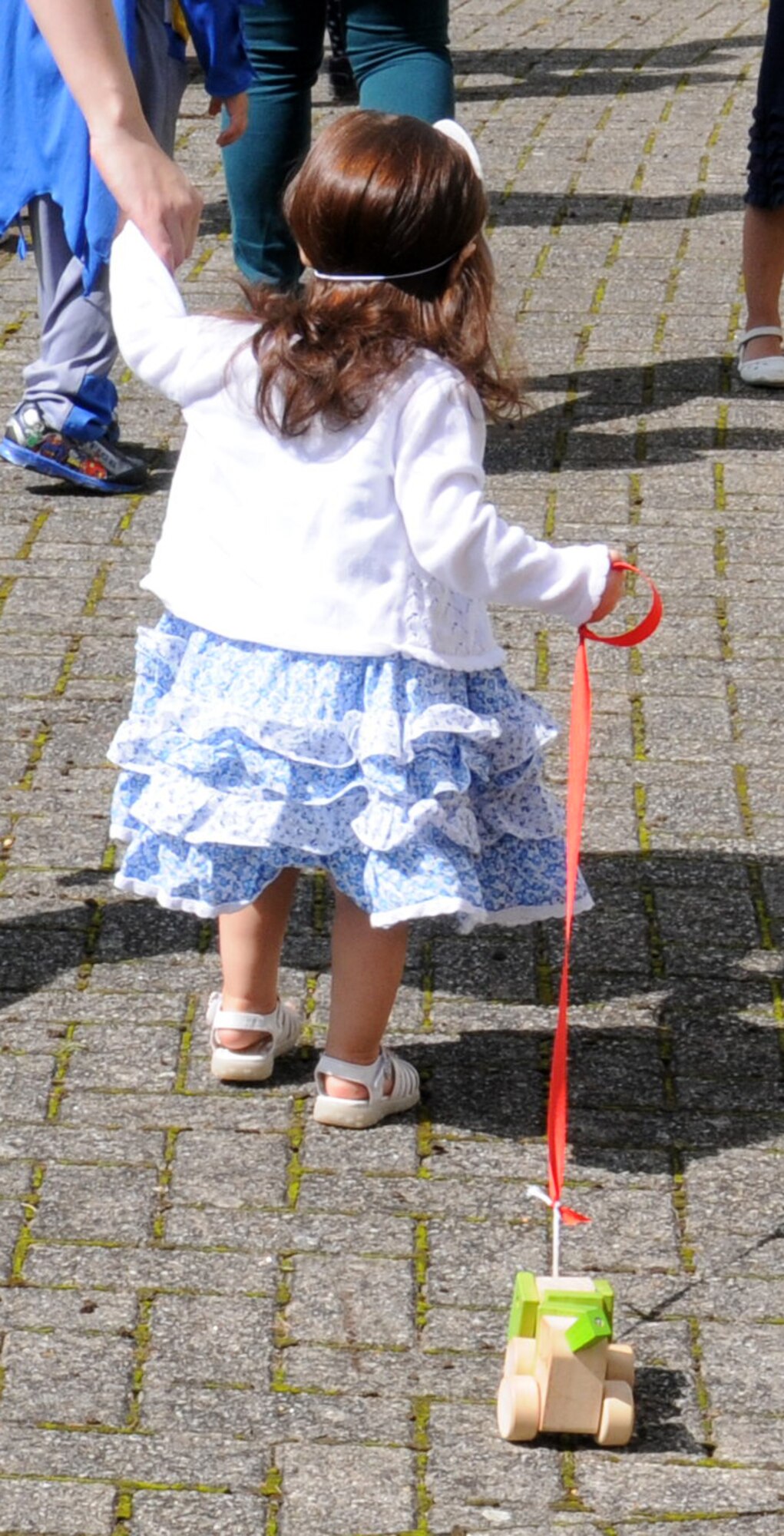 A Team Mildenhall child takes part in a “Paws to Read” pet parade and costume contest Aug. 13, 2014, at the library on RAF Mildenhall, England. The girl walked her own model dog during the parade and organizers encouraged all guests to bring a real pet or a stuffed animal for the parade. (U.S. Air Force photo/Gina Randall/Released)