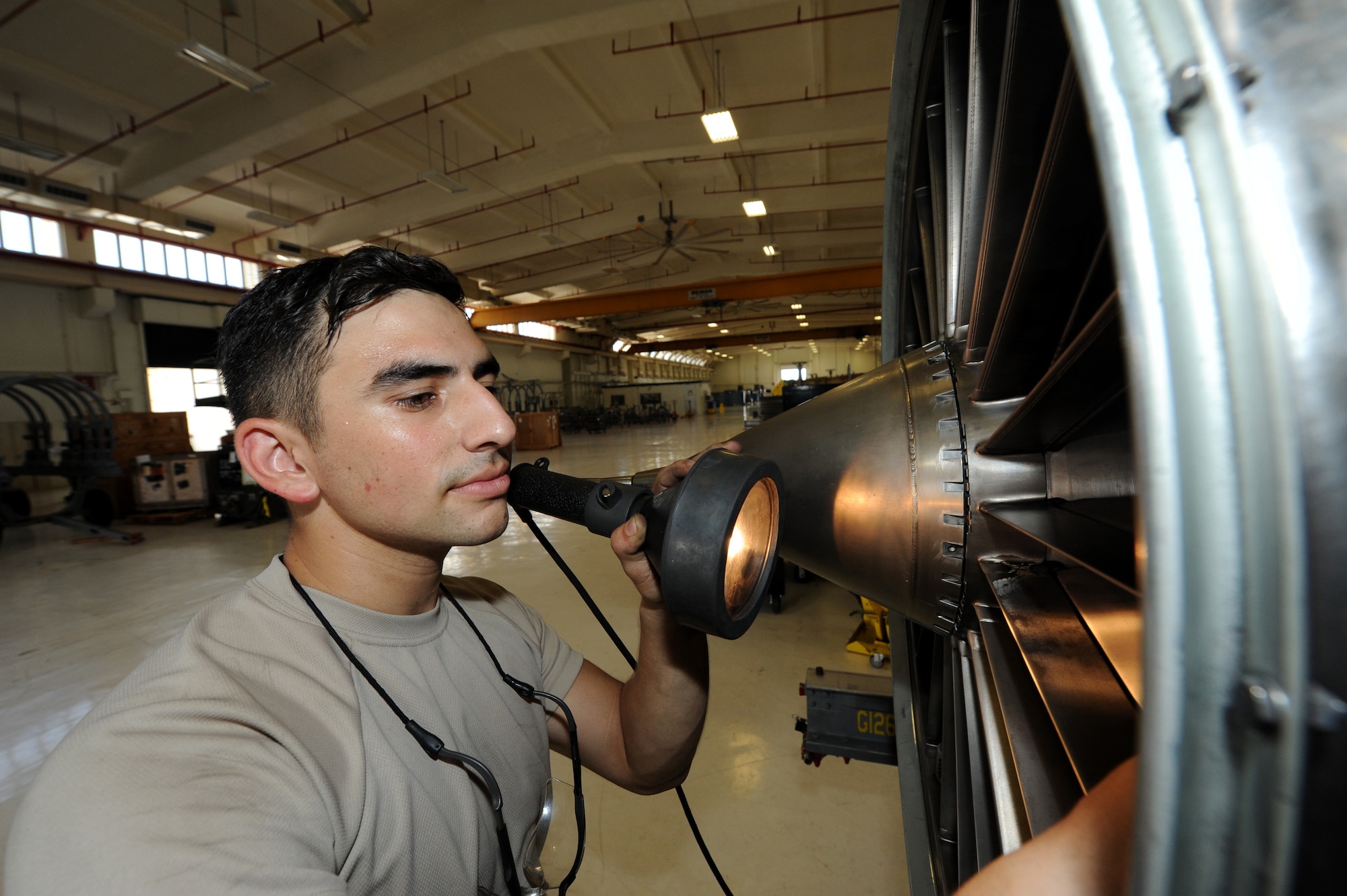 U.S. Air Force Airman 1st Class Benjamin Sanchez, 18th Component Maintenance Squadron aerospace propulsion apprentice, inspects a fan on the F-100 jet engine on Kadena Air Base, Japan, Aug. 19, 2014. The F-100 engines are part of the F-15 fighter jet assigned here whose primary mission is to provide ready air and space power to promote U.S. interests in the Asia-Pacific region during peacetime, through crisis and in war. (U.S. Air Force photo by Airmen 1st Class Stephen G. Eigel/Released) 