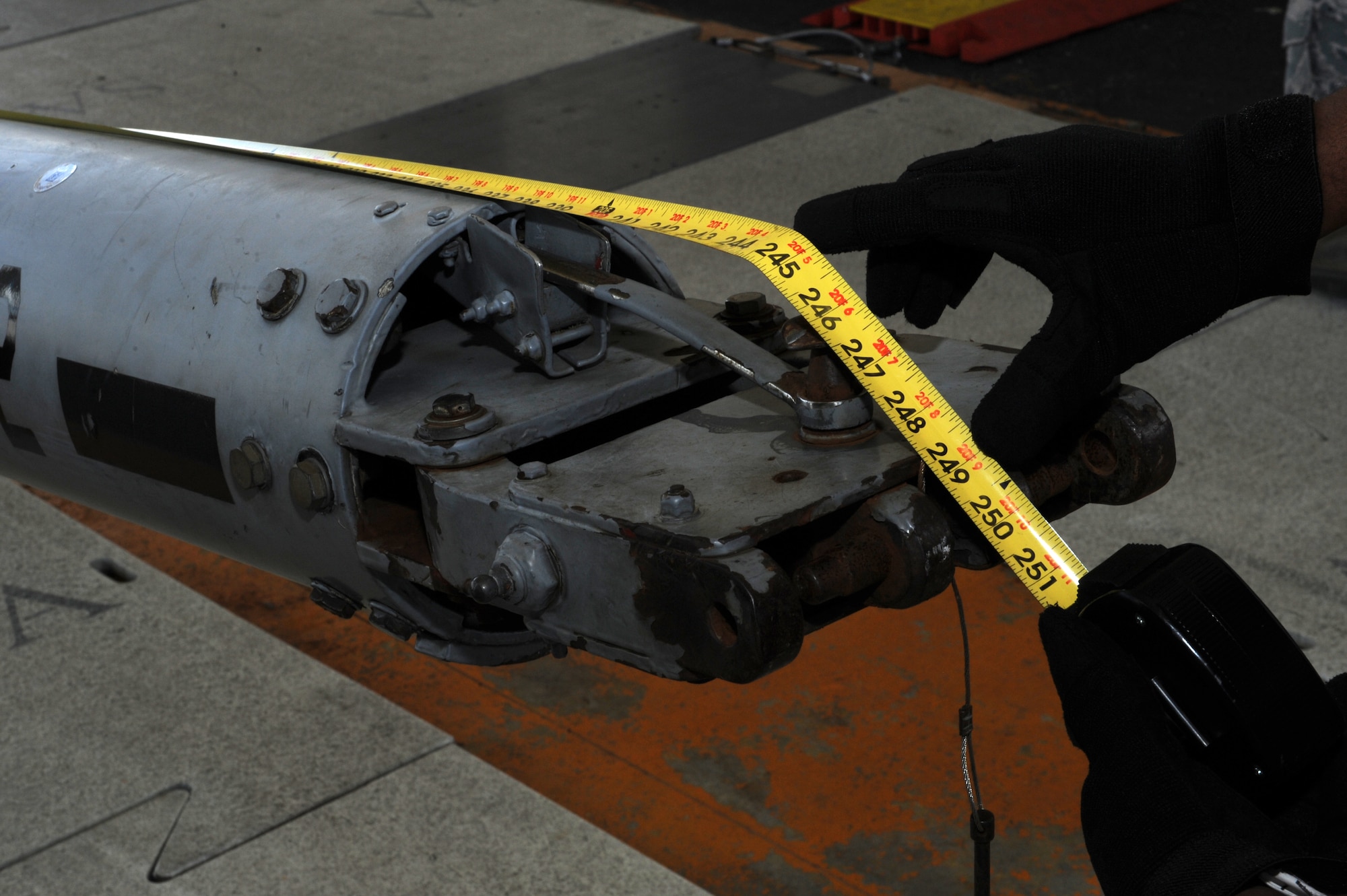 An Airman from the 18th Logistics Readiness Squadron checks the length of equipment against a cargo manifest on Kadena Air Base, Japan, Aug. 19, 2014. Airmen from the 18th LRS measured and weighed aircraft parts and maintenance equipment to ensure proper transportation during a mission focused exercise. (U.S. Air Force photo by Airman 1st Class Zade C. Vadnais/Released)