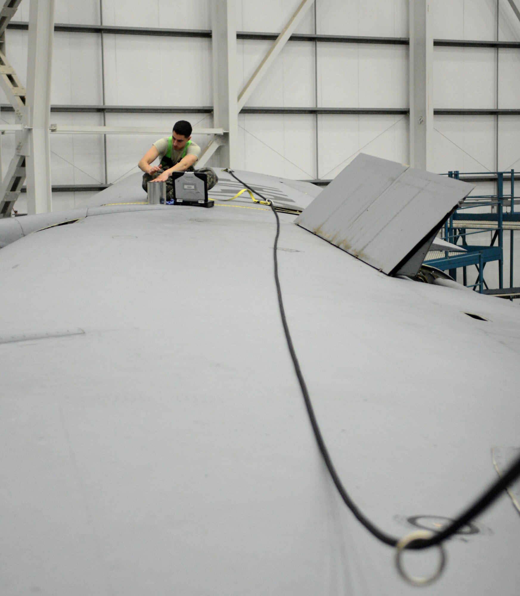 U.S. Air Force Senior Airman Joseph Flores, 100th Maintenance Squadron crew chief from Hollister, Calif., cleans up after applying lubrication to a section of gears in the wing of a KC-135 Stratotanker during an isochronal inspection Aug. 14, 2014, on RAF Mildenhall, England. Aircraft undergo ISO inspections, which occur at set intervals for each plane, to ensure they are mission-ready and safe to fly. (U.S. Air Force photo/Airman 1st Class Dillon Johnston/Released)