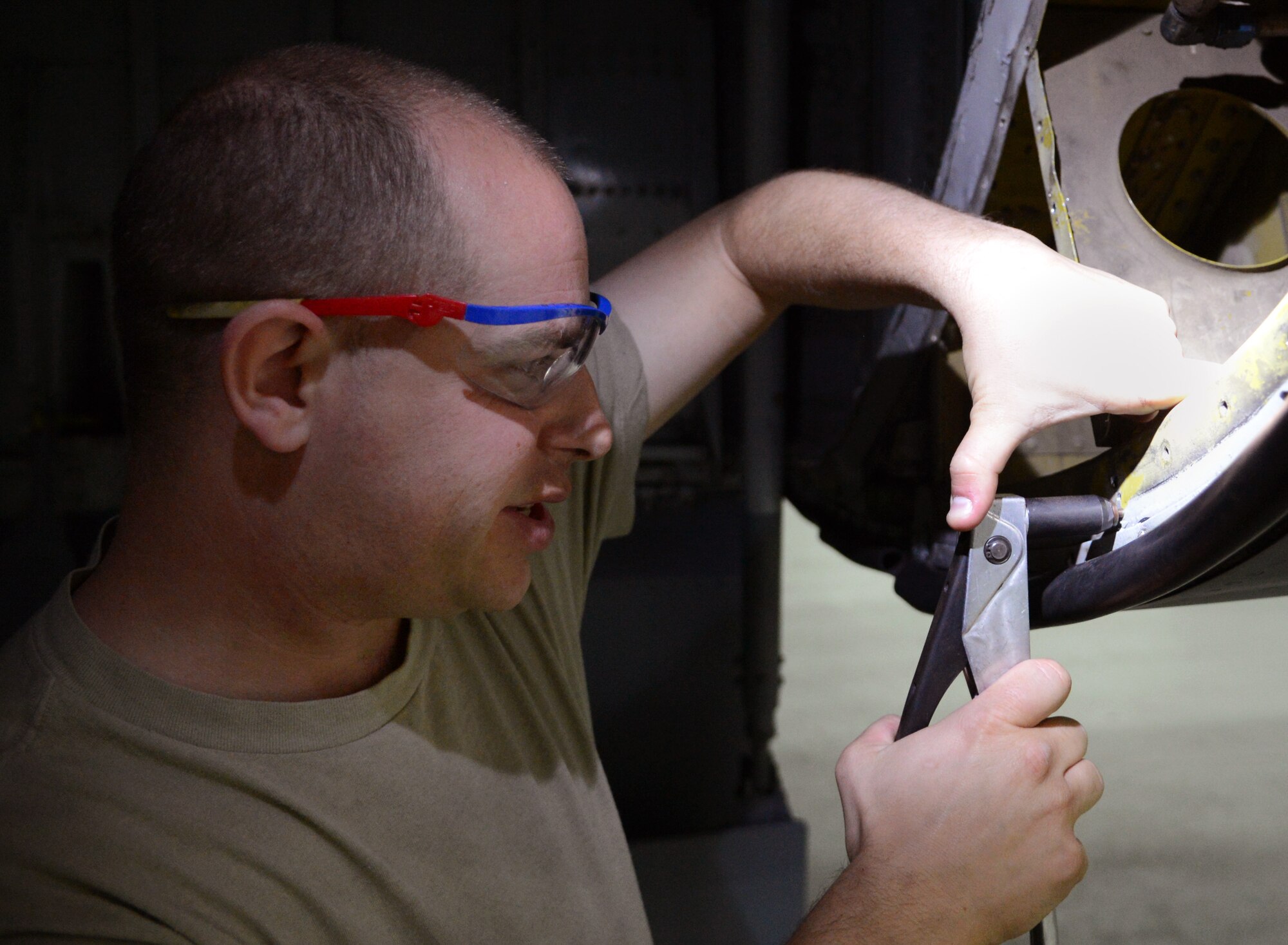 U.S. Air Force Staff Sgt. Corey Shipe, 100th Maintenance Squadron sheet metal craftsman from Savage, Md., attaches nuts to the undercarriage of a KC-135 Stratotanker during an isochronal inspection Aug. 14, 2014, on RAF Mildenhall, England. Each part of the aircraft is meticulously checked for any defects which could cause the plane to be unfit for flight over during an ISO inspection which occurs at set intervals for each plane. (U.S. Air Force photo/Airman 1st Class Dillon Johnston/Released)