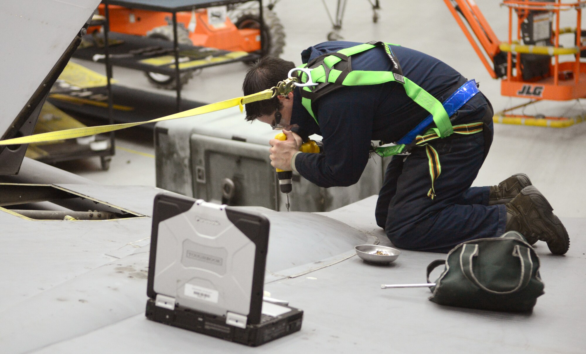 U.S. Air Force Staff Sgt. Adam Taylor, 100th Maintenance Squadron crew chief from Houston, Texas, screws paneling on to the wing of a KC-135 Stratotanker during an isochronal inspection, which occurs at set intervals for each plane, Aug. 14, 2014, on RAF Mildenhall, England. Panels are removed from the plane to access parts which need to be repaired or replaced. (U.S. Air Force photo/Airman 1st Class Dillon Johnston/Released)