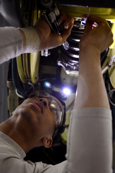 U.S. Air Force Airman 1st Class Davon Hutchinson, 100th Maintenance Squadron aircraft hydraulics systems journeyman from Mount Holly, N.J., finishes repairing a boom on a KC-135 Stratotanker during an isochronal inspection Aug. 14, 2014, on RAF Mildenhall, England. During the inspection, which occur at set intervals for each plane, it was found that the boom attached to the plane was failing, so it was completely replaced. (U.S. Air Force photo/Airman 1st Class Dillon Johnston/Released)