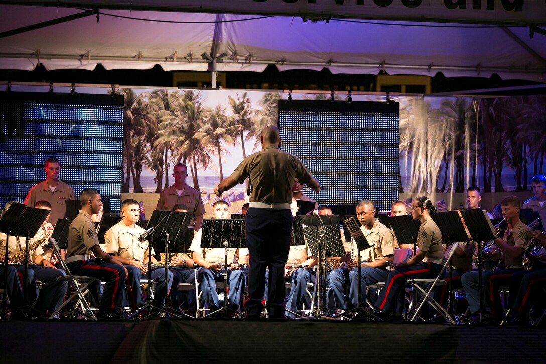 Members of the III Marine Expeditionary Force Band perform during an evening concert July 21 at the liberation carnival grounds in Barrigada, Guam. The band performed a list of patriotic songs in spirit of the 70th anniversary of the liberation of Guam. The band was in Guam July 18-22 to provide musical support and Marine Corps representation for liberation anniversary events. The performance was one of several from the III MEF Band during their time in Guam.