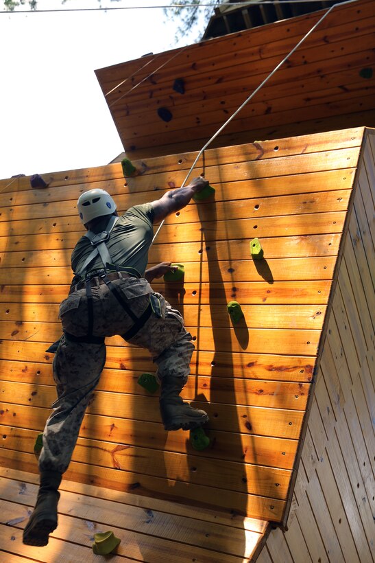 Staff Sgt. Garland Brown ascends a rock-climbing wall of the Devil Dog Dare course at Marine Corps Air Station Cherry Point, N.C., Aug. 13, 2014. Brown is a tactical data systems administrator chief with Marine Tactical Air Command Squadron 28 and native of Chicago.