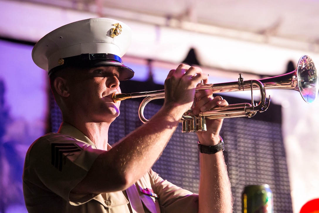 Sgt. Bryon Z. Reed sounds ‘Taps’ during an evening concert July 20 at the liberation carnival grounds in Barrigada, Guam. The tune was played on the eve of the 70th anniversary of Guam’s liberation in tribute to the men and women who perished during the occupation. The III Marine Expeditionary Force Band was in Guam July 18-22 to provide musical support and Marine Corps representation for liberation anniversary events. Reed is a Cambridge, Ohio, native and trumpeter with the III MEF Band. 