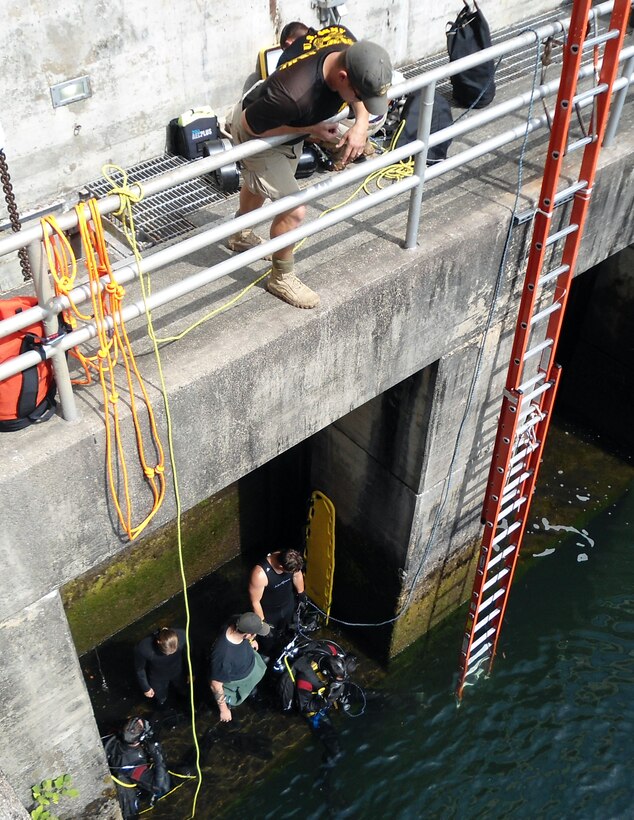 Fort Eustis, Virginia-based Soldier divers prepare to inspect the downstream side of Philpott Dam to look for and remove debris during a routine inspection. A U.S. Army Corps of Engineers regimental asset, the team also does reconnaissance, demolition and salvage in depths up to 190 feet. (USACE photo by Powell Hughes)     