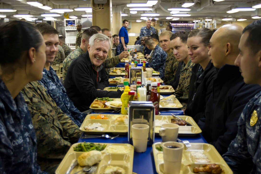 Secretary of the Navy Ray Mabus eats dinner with Marines and Sailors with Special Purpose Marine Air Ground Task Force South and the future amphibious assault ship USS America (LHA 6) in the mess deck aboard the ship, Aug. 19, 2014. The dinner with the Marines and Sailors allowed for topics of interest to be discussed on a personal level. In addition to dinner, Mabus toured the ship, held an all-hands call to address the crew and attended an ice cream social. Visits like this remind the Marines and Sailors with America and the SPMAGTF of the significance of the work they are doing. SPMAGTF-South is embarked aboard America in support of her maiden transit, “America Visits the Americas.” Through partner-nation activities, theater security events and key leader engagements, the transit aims to demonstrate the flexibility, utility and unparalleled expeditionary capability the Navy-Marine Corps team provides our nation and partners. (U.S. Marine Corps Photo by Cpl. Donald Holbert/ Released)