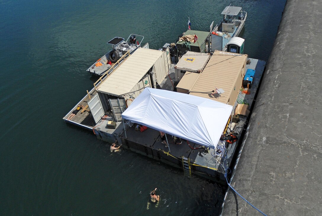 A floating work station for Army divers is affixed to the inner wall of Phipott Dam for a routine inspection. (USACE photo by Powell Hughes)  