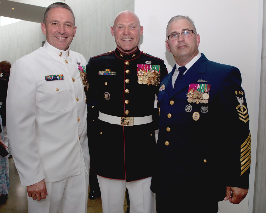Sgt. Maj. Micheal P. Barrett, the 17th Sergeant Major of the Marine Corps, and Master Chief Petty Officer Michael D. Stevens, the 13th Master Chief Petty Officer of the Navy (left), and Master Chief Petty Officer Steven W. Cantrell, the 12th Master Chief Petty Officer of the Coast Guard (right), at the Sunset Parade reception at the Women in Military Service For America Memorial, in Arlington, Va., on Aug. 12, 2014. (U.S. Marine Corps photo by Lance Cpl. Jacob R. Bozic/ Released) 