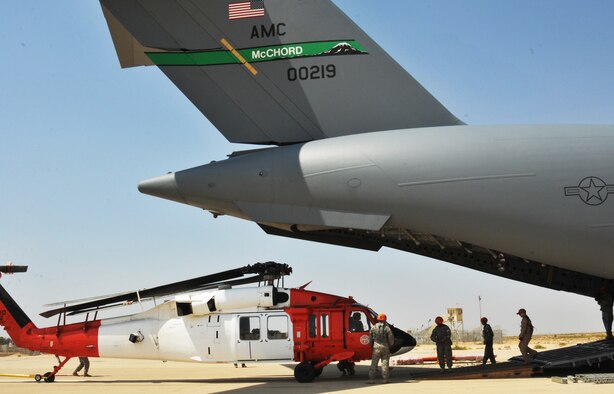 Soldiers and Airmen load a UH-60 Black Hawk into an Air Force C17 Globemaster III Aug. 19, 2104, at an old Israeli airstrip in the Sinai Peninsula of Egypt. The airstrip is now used by the Multinational Force and Observers stationed in Sinai Egypt. The Black Hawk was loaded into the belly of the C-17 and transported to Germany where it will undergo advanced maintenance. The C-17 is from the 62nd Airlift Wing, based out of Joint Base Lewis-McChord, Wash. (U.S. Army photo/Sgt. Thomas Duval)
