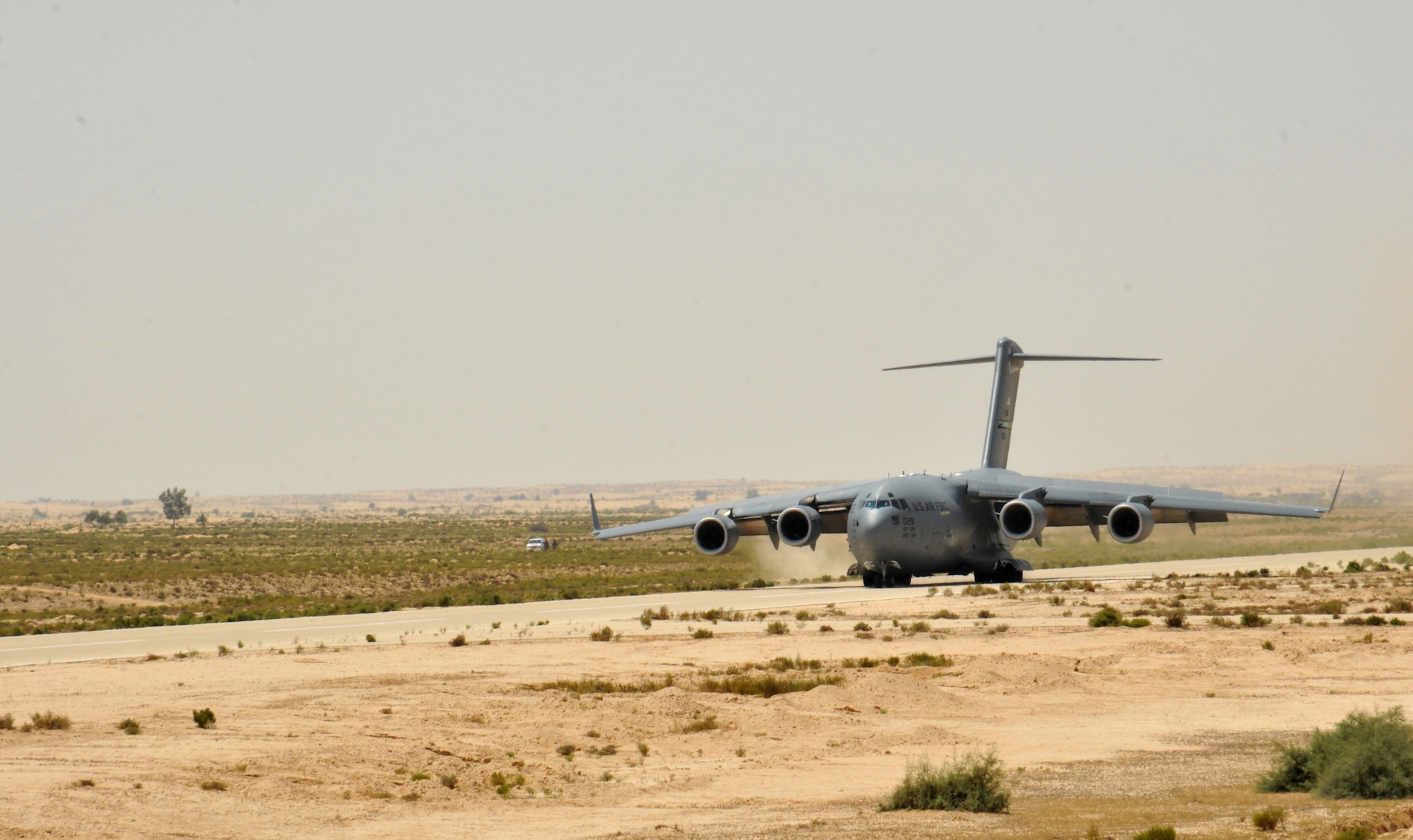 An Air Force C17 Globemaster III lands on an old airstrip  Aug. 19, 2014, in the Sinai Peninsula of Egypt. the airstrip is now used by the Multinational Force and Observers stationed in Sinai, Egypt. The Airmen landed in the Sinai to help provide airlift support of a UH-60 Black Hawk to Soldiers from the Aviation Company, 1st Support Battalion, Task force Sinai. The Blackhawk was loaded into the belly of the C-17 Globemaster and transported to Germany where it will undergo advanced maintenance. The C-17 is from the 62nd Airlift Wing, based out of Joint Base Lewis-McChord, Wash. (U.S. Army Photo/Sgt. Thomas Duval)