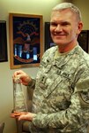 Army Maj. Gen. David Sprynczynatyk, North Dakota National Guard adjutant general, displays the award the Guard received from the Cass County Sheriff's office. The inscription reads "In recognition for your assistance during the emergency response in the Red River Valley."