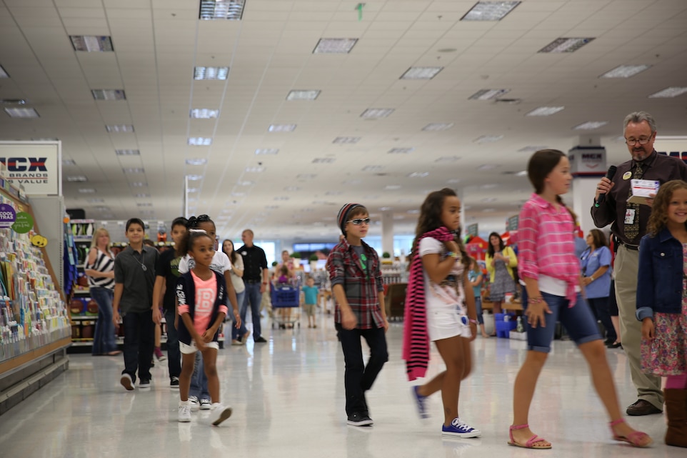 Combat Center children showcase their outfits donated by American Friends of our Armed Forces during a fashion show at the Main Exchange Aug. 15, 2014. The back to school week was well received by families that attended. (Official Marine Corps Photo by Cpl. Kathryn Seiler/Released)