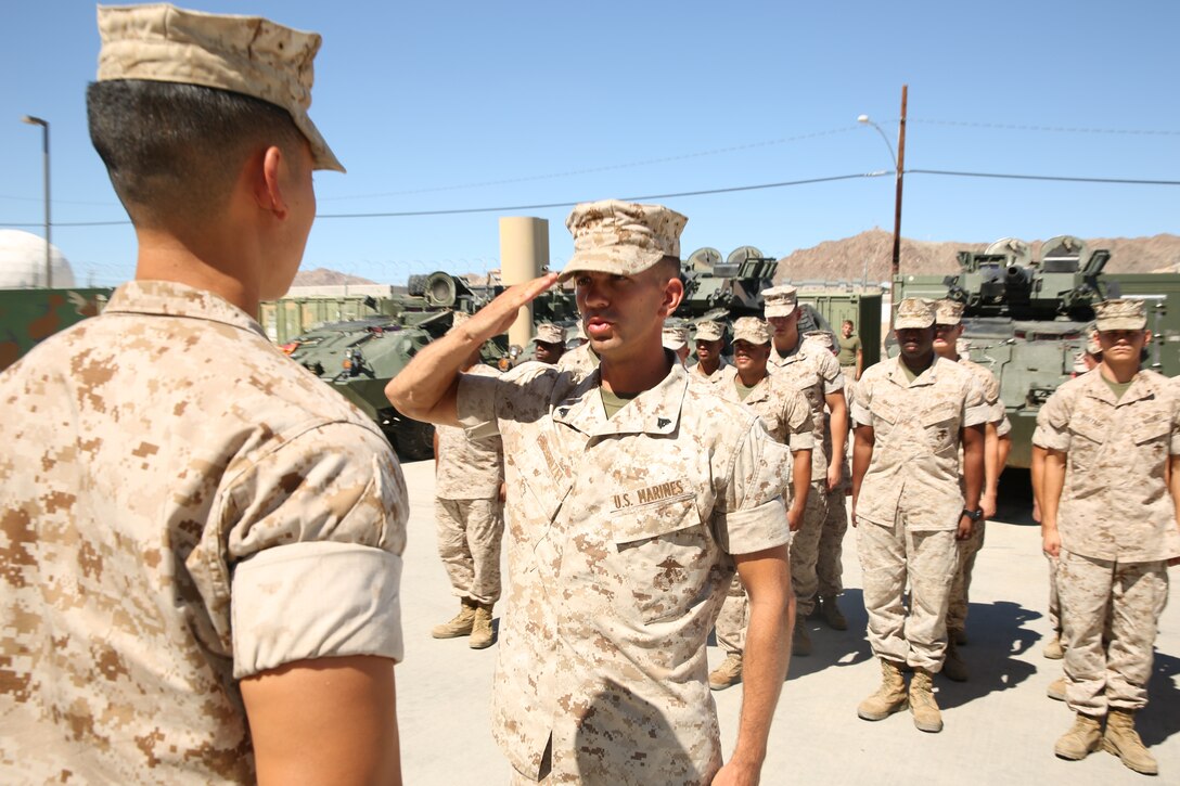 Cpl. Arthur E. Krenzel III, field radio operator, 3rd Light Armored Reconnaissance Battalion, salutes Capt. Kelvin Chew, communications officer, S-6, 3rd Light Armored Reconnaissance Battalion, during his meritorious promotion ceremony at the Communications Building of 3rd LAR, Aug. 15, 2014.