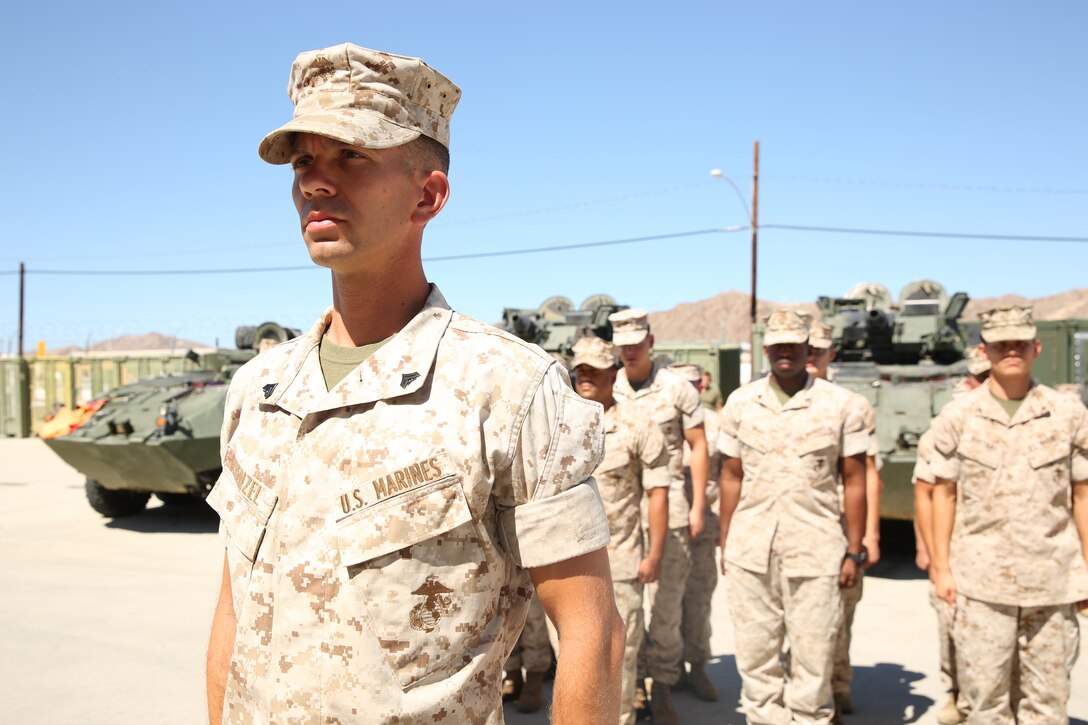 Cpl. Arthur E. Krenzel III, field radio operator, 3rd Light Armored Reconnaissance Battalion, stands at attention in front of other communications Marines in his section during the reading of his promotion warrant as part of the meritorious promotion ceremony at the Communications Building of 3rd LAR, Aug. 15, 2014.



