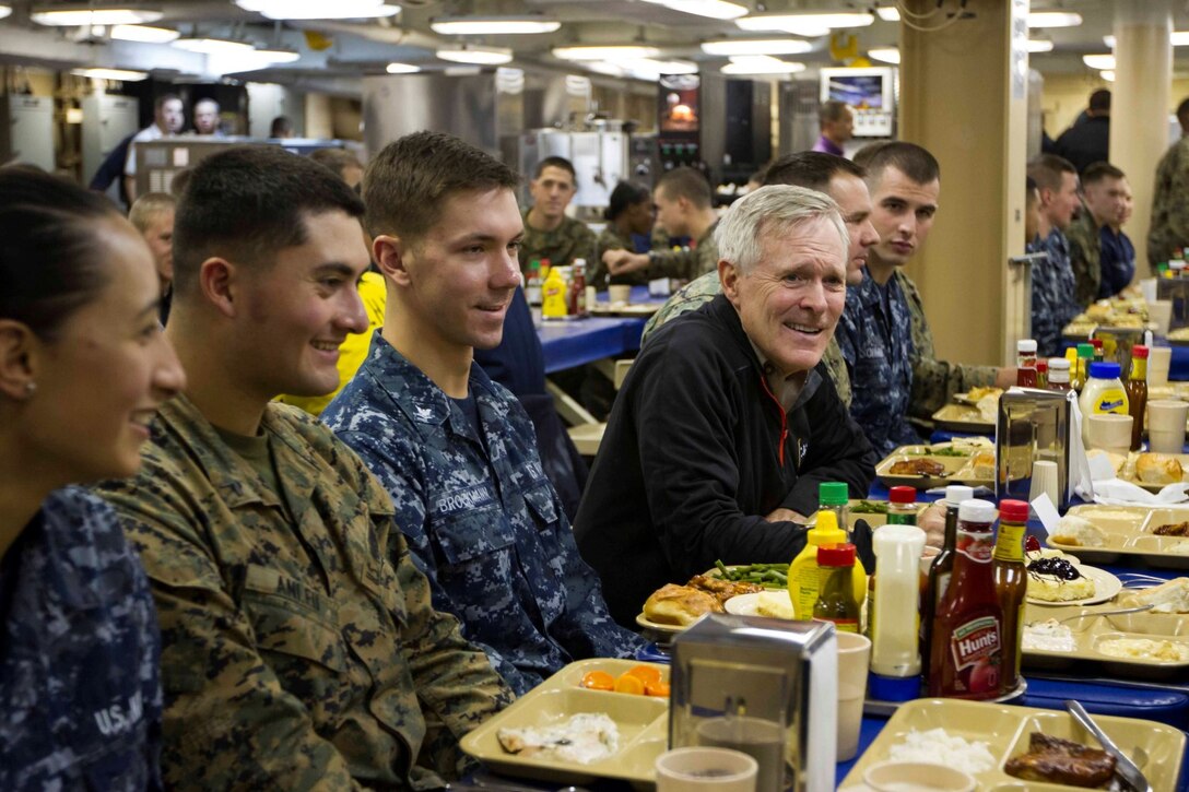 Secretary of the Navy Ray Mabus eats dinner with Marines and Sailors with Special Purpose Marine Air Ground Task Force South and the future amphibious assault ship USS America (LHA 6) in the mess deck aboard the ship, Aug. 19, 2014. The dinner with the Marines and Sailors allowed for topics of interest to be discussed on a personal level. In addition to dinner, Mabus toured the ship, held an all-hands call to address the crew and attended an ice cream social. Visits like this remind the Marines and Sailors with America and the SPMAGTF of the significance of the work they are doing. SPMAGTF-South is embarked aboard America in support of her maiden transit, “America Visits the Americas.” Through partner-nation activities, theater security events and key leader engagements, the transit aims to demonstrate the flexibility, utility and unparalleled expeditionary capability the Navy-Marine Corps team provides our nation and partners. (U.S. Marine Corps Photo by Cpl. Donald Holbert/ Released)