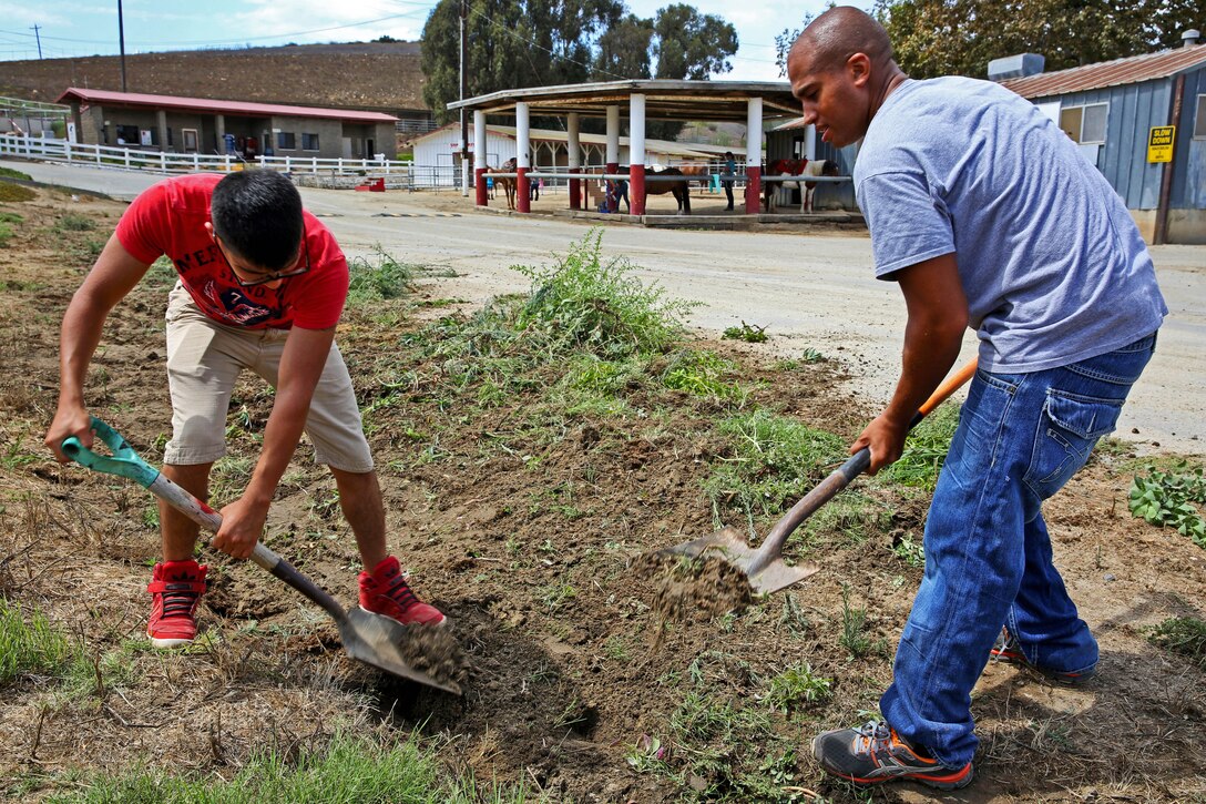 CAMP PENDLETON, Calif. - Cpl. Richard Carabello (right) and Cpl. Edgar Duram(left), heavy equipment specialists with 1st Maintenance Battalion, aide the Stepp Stables by volunteering here, Aug. 20.

According to Carabello, every two weeks Marines from 1st Maintenance Bn. volunteer in order to improve the Corps and Community around them.
