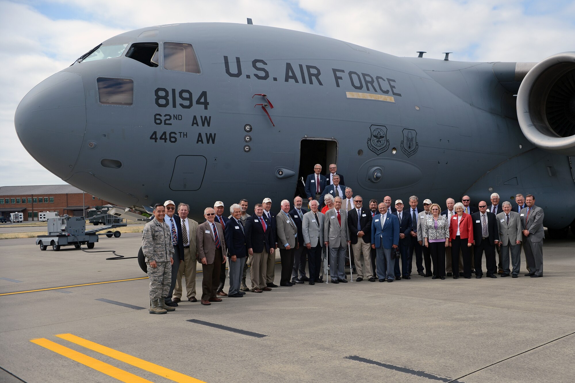 Members of the Defense Orientation Conference Association conclude a base tour with a group photo in front a C-17 Globemaster III Aug. 20, 2014, at Joint Base Lewis-McChord, Wash. Visiting JBLM enabled DOCA members to pass on the information they learned to others as they continued to provide a permanent medium for cooperation between themselves and Departments of Defense and State. (U.S. Air Force photo/Airman 1st Class Jacob Jimenez)