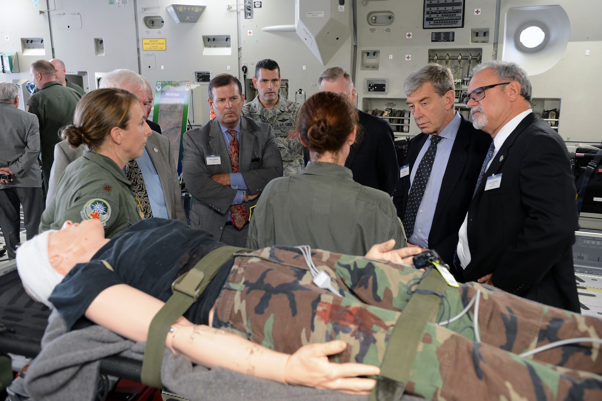Maj. Shana Weber(left), 446th Aeromedical Evacuation Squadron flight nurse, and Master Sgt. Charlene Taylor, 446th AES aeromedical technician, brief members of the Defense Orientation Conference Association on aeromedical evacuation Aug. 8, 2014, at Joint Base Lewis-McChord, Wash. After spending a day on Lewis North, the group spent Wednesday on McChord Field visiting with leadership, touring the Western Air Defense Sector and exploring a C-17 Globemaster III static display. (U.S. Air Force photo/Airman 1st Class Jacob Jimenez)