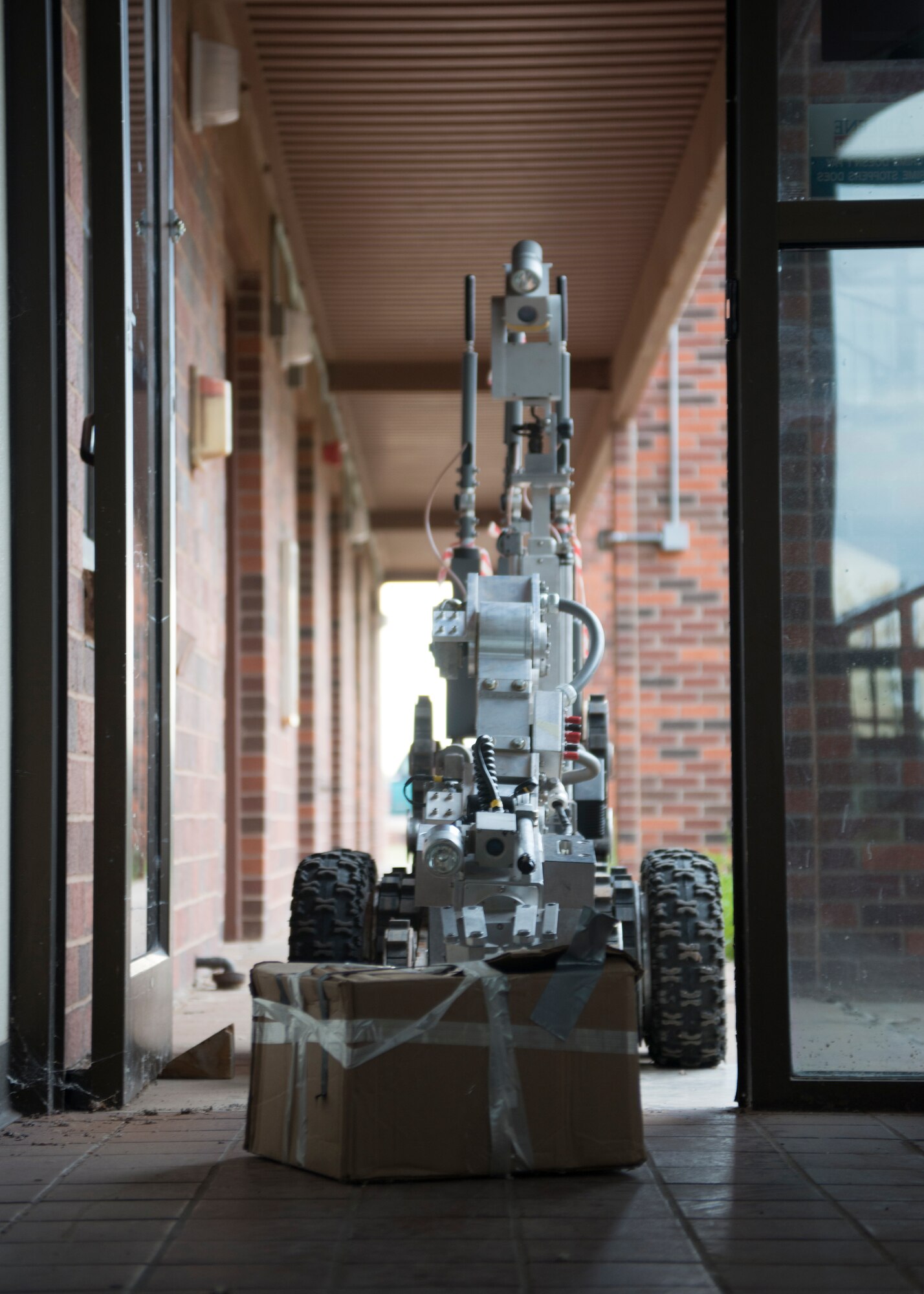 An F6A Explosive Ordnance Disposal robotic system drags a suspicious package from a building during a training scenario Aug. 12, 2014, at Dyess Air Force Base, Texas. EOD teams from Dyess and Fort Hood, Texas, trained here Aug. 11- 12 to increase knowledge and experience for home station and deployment operations. (U.S. Air Force photo by Senior Airman Peter Thompson/Released)