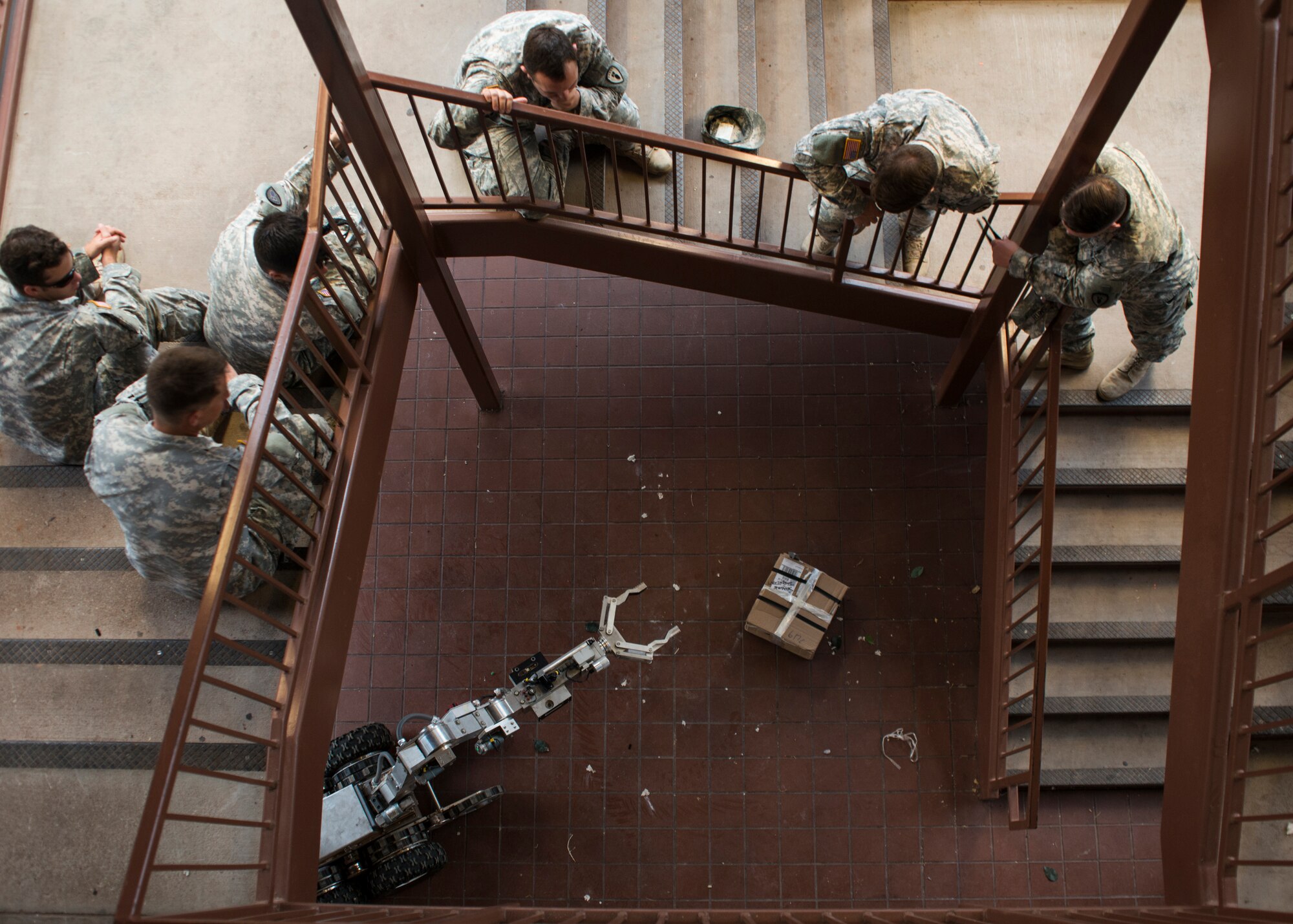 75th Ordnance Disposal Company, 79th Ordnance Disposal Battalion, 71st Ordnance Group Explosive Ordnance Disposal team members, watch as an F6A robot approaches a simulated improvised explosive device Aug. 12, 2014, at Dyess Air Force Base, Texas. Team members from the 75th OD joined Airmen from the 7th Civil Engineer Squadron Explosive Ordnance Disposal flight, to accomplish joint training. Both units gained hands-on experience with EOD robotic systems and equipment that they would otherwise not have access to at their home station. The Talon and Packbot systems provided by the 75th OD are two of the most common robots used by Air Force EOD members in deployed environments. (U.S. Air Force photo by Senior Airman Peter Thompson/Released)