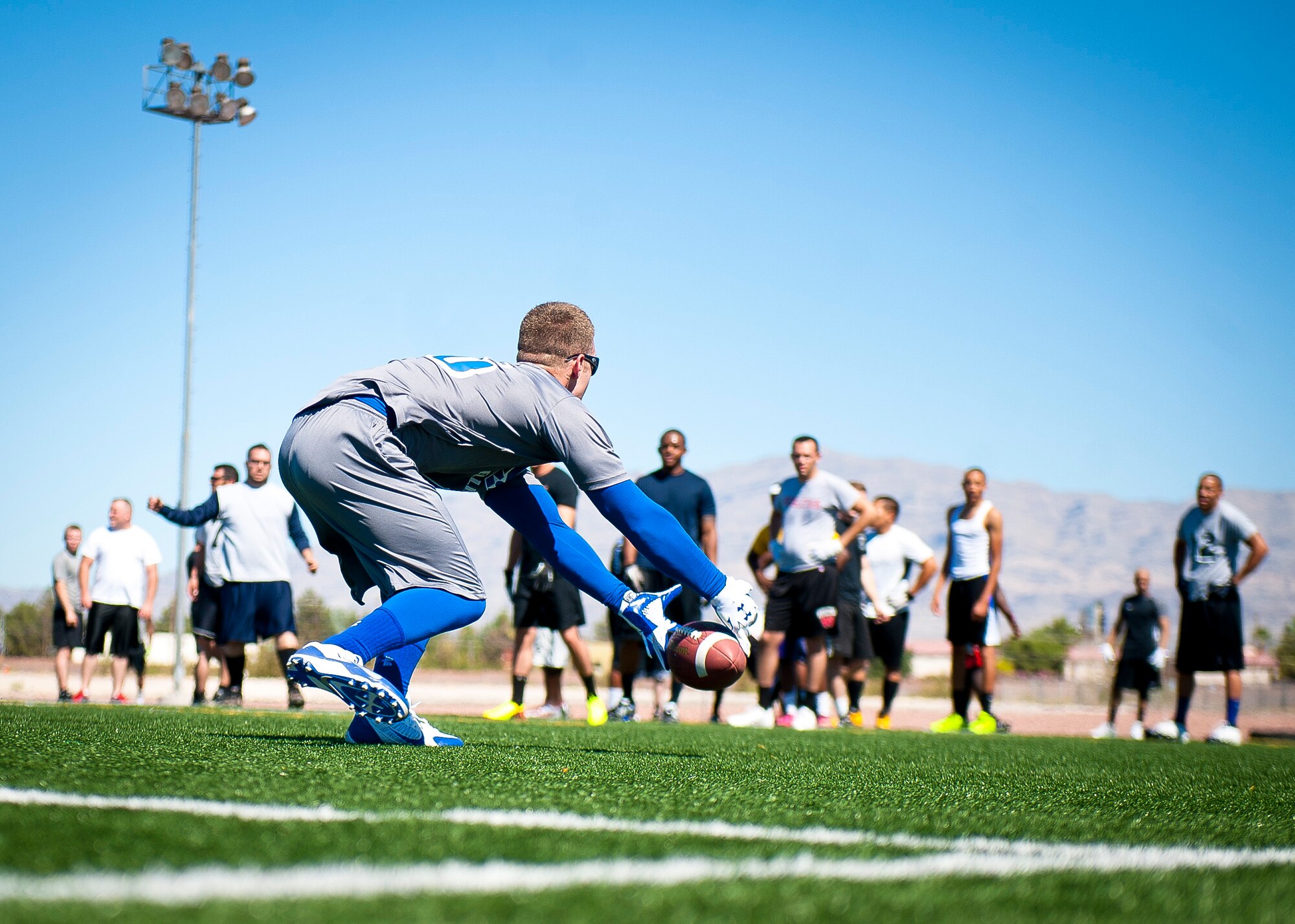 Darren Kressin, 57th Maintenance Group, attempts to catch a pass during flag football tryouts at Nellis Air Force Base, Nev., Aug. 16, 2014. Airmen were trying out for the base team and the chance to play other teams in Las Vegas. (U.S. Air Force photo by Airman 1st Class Mikaley Towle)