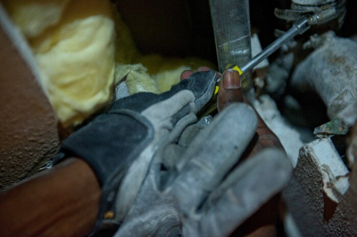 Staff Sgt. Alan Franklin, 99th Civil Engineer Squadron water and fuels systems maintenance craftsman, loosens a screw on a drain pipe in order to reach the cleanout of the pipe at the Nellis Inn on Nellis Air Force Base, Nev., Aug. 19, 2014. Once Franklin could reach the cleanout, he was able to unclog the pipe without taking it out of the wall or replacing it. Since January 2014, Franklin and other water and fuels systems maintenance technicians have completed 1,860 job orders and spent 5,634 preventative-maintenance hours to ensure the base’s continuous water flow is uninterrupted. (U.S. Air Force photo by Staff Sgt. Siuta B. Ika)