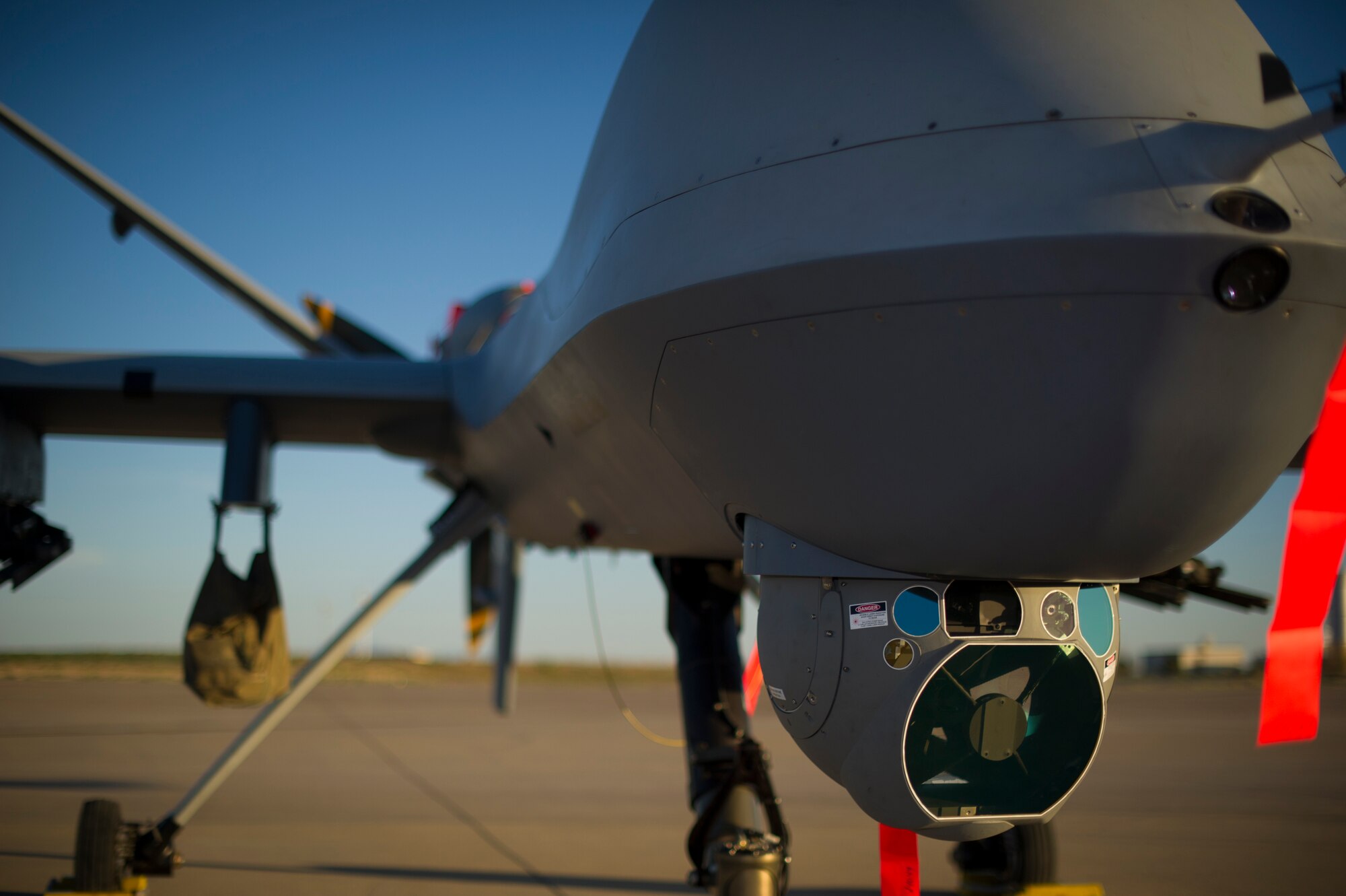 An MQ-9 Reaper sits on the flight line of Holloman Air Force Base, N.M., Aug. 19, prior to maintenance that will keep it flying and training the next generation of Air Force pilots and sensor operators. The MQ-9 Reaper is a medium-to-high altitude, long endurance unmanned aircraft system. The MQ-9's primary mission is as a persistent hunter-killer against emerging targets to achieve joint force commander objectives. The MQ-9's alternate mission is to act as an intelligence, surveillance and reconnaissance asset, employing sensors to provide real-time data to commanders and intelligence specialists at all levels.(U.S. Air Force photo by Airman 1st Class Aaron Montoya/Released)